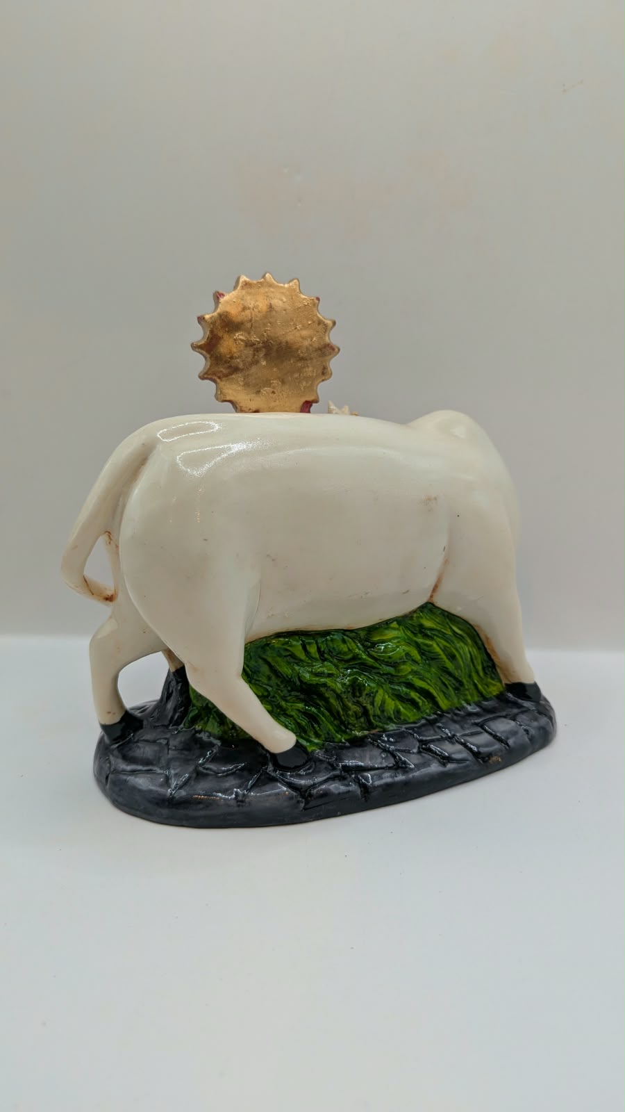 Krishna with white cow statue, back view