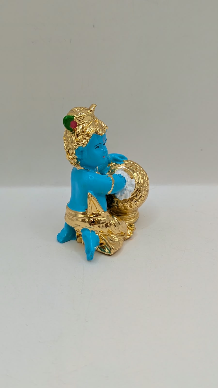 Blue and gold Baby Krishna murti with butter pot, side view