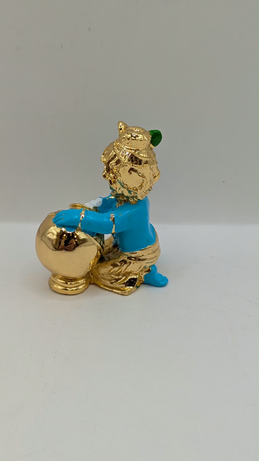 Blue and gold Baby Krishna murti with butter pot, back view