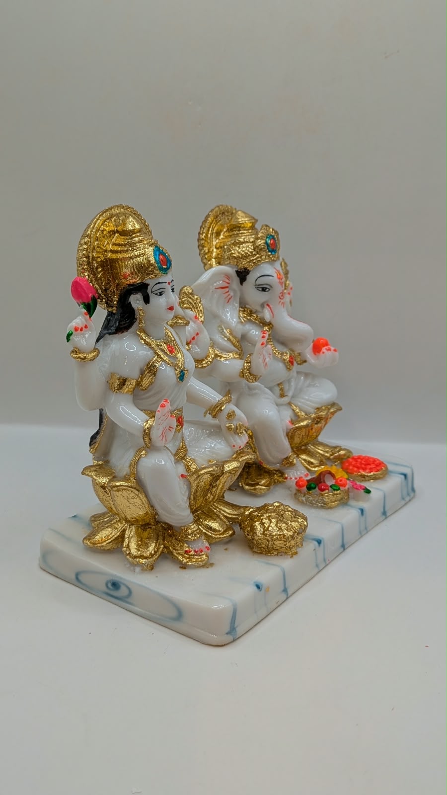 White and gold Laxmi Ganesh statue, side view