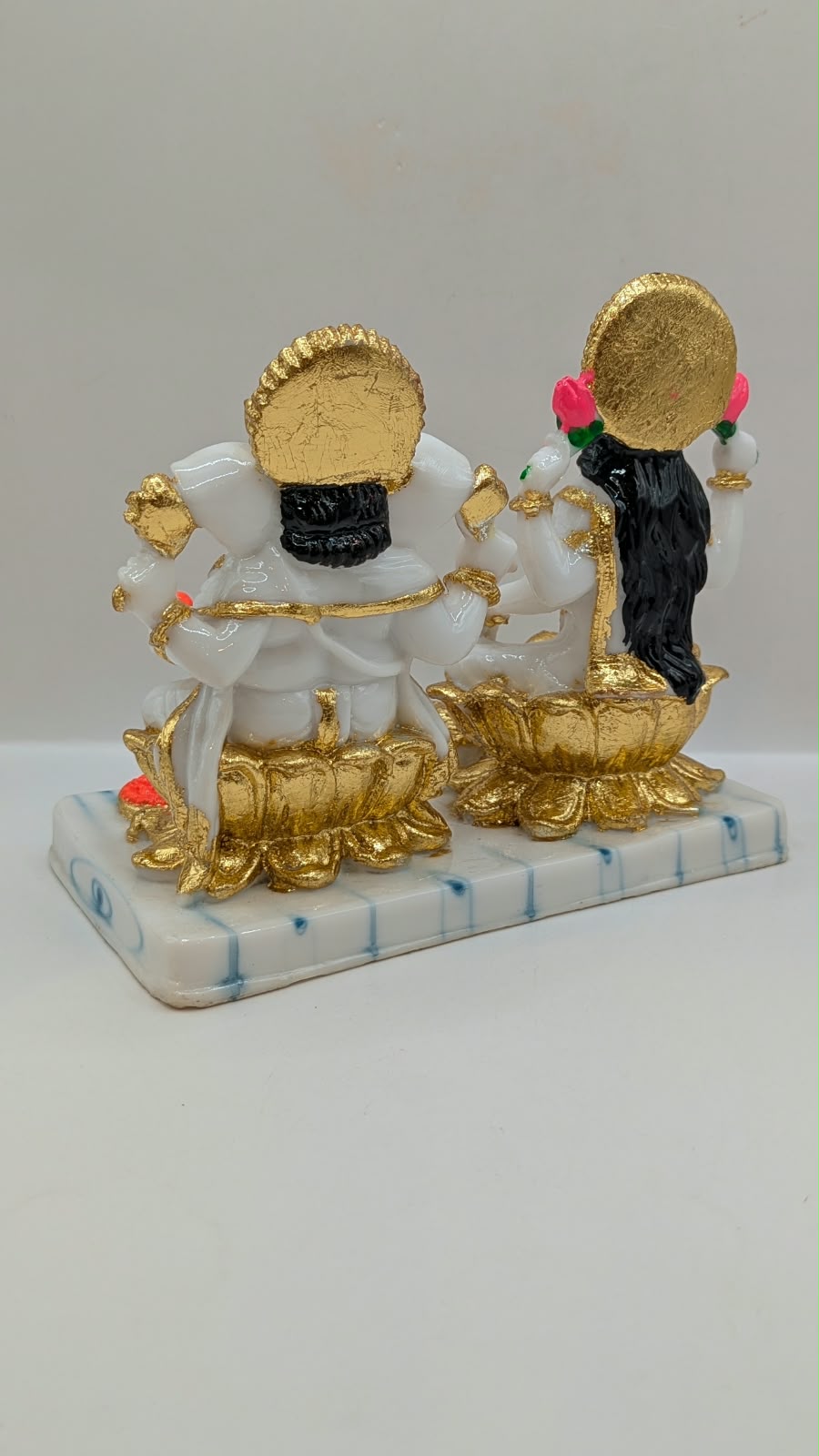 White and gold Laxmi Ganesh statue, back view