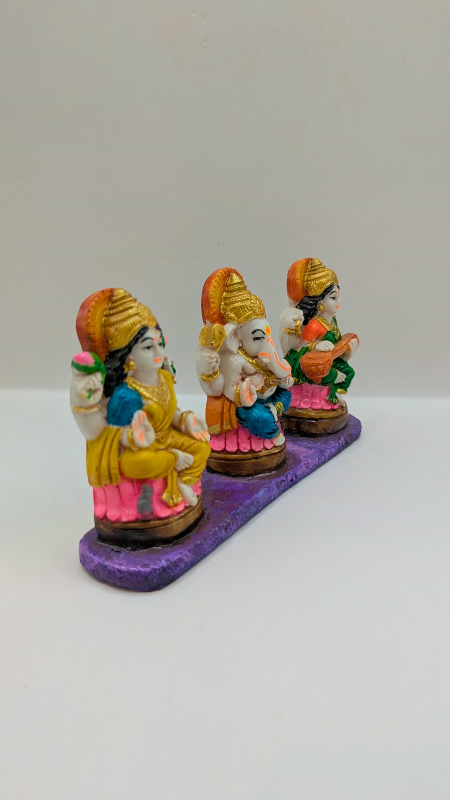 Colourful Laxmi Ganesh Saraswati statue set, side view