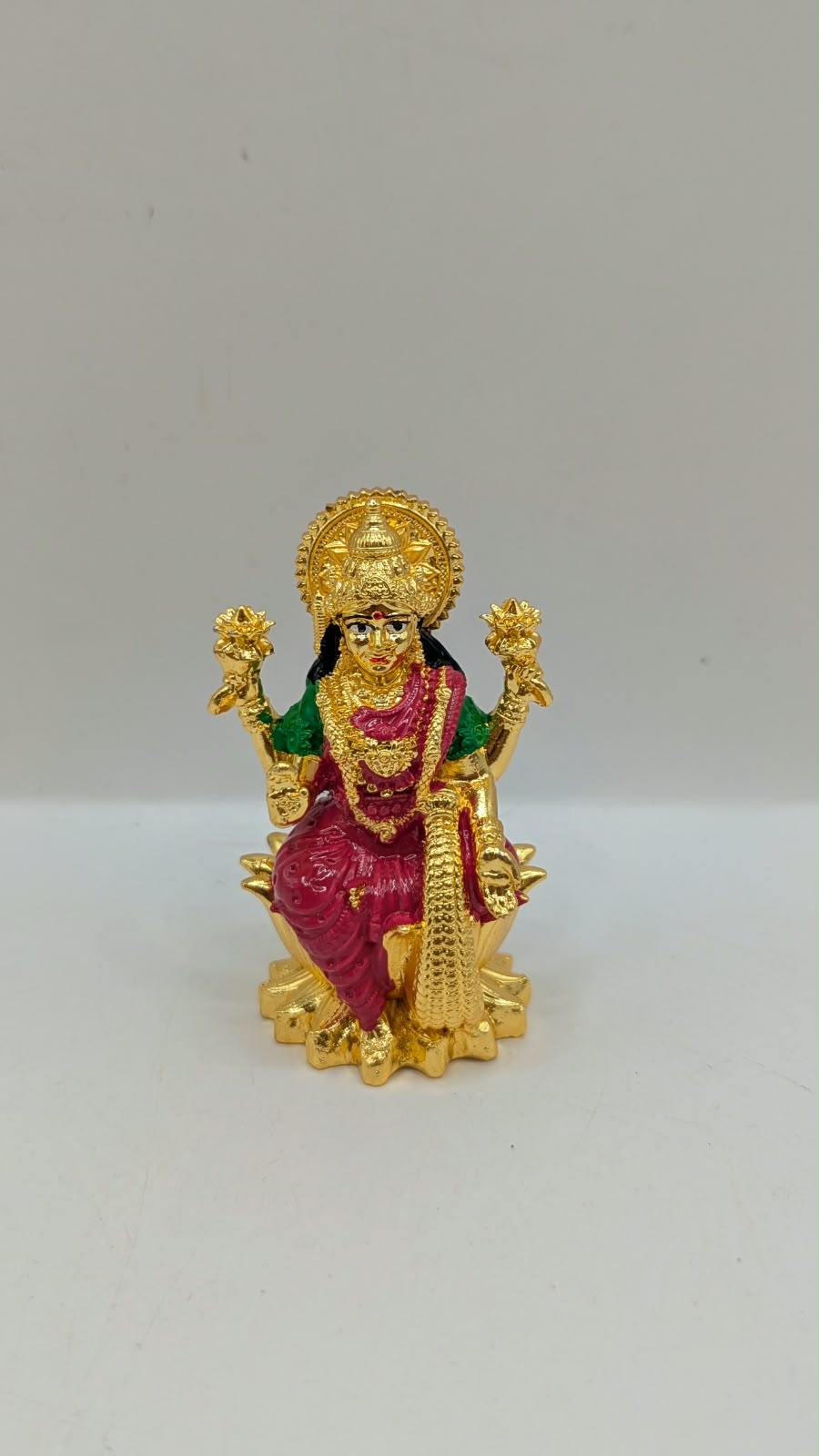 Gold Laxmi murti with pink saree, front view