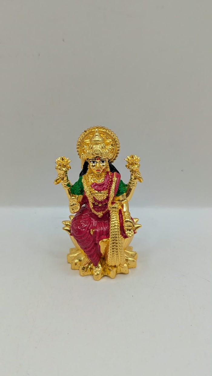 Gold Laxmi murti with pink saree, front view