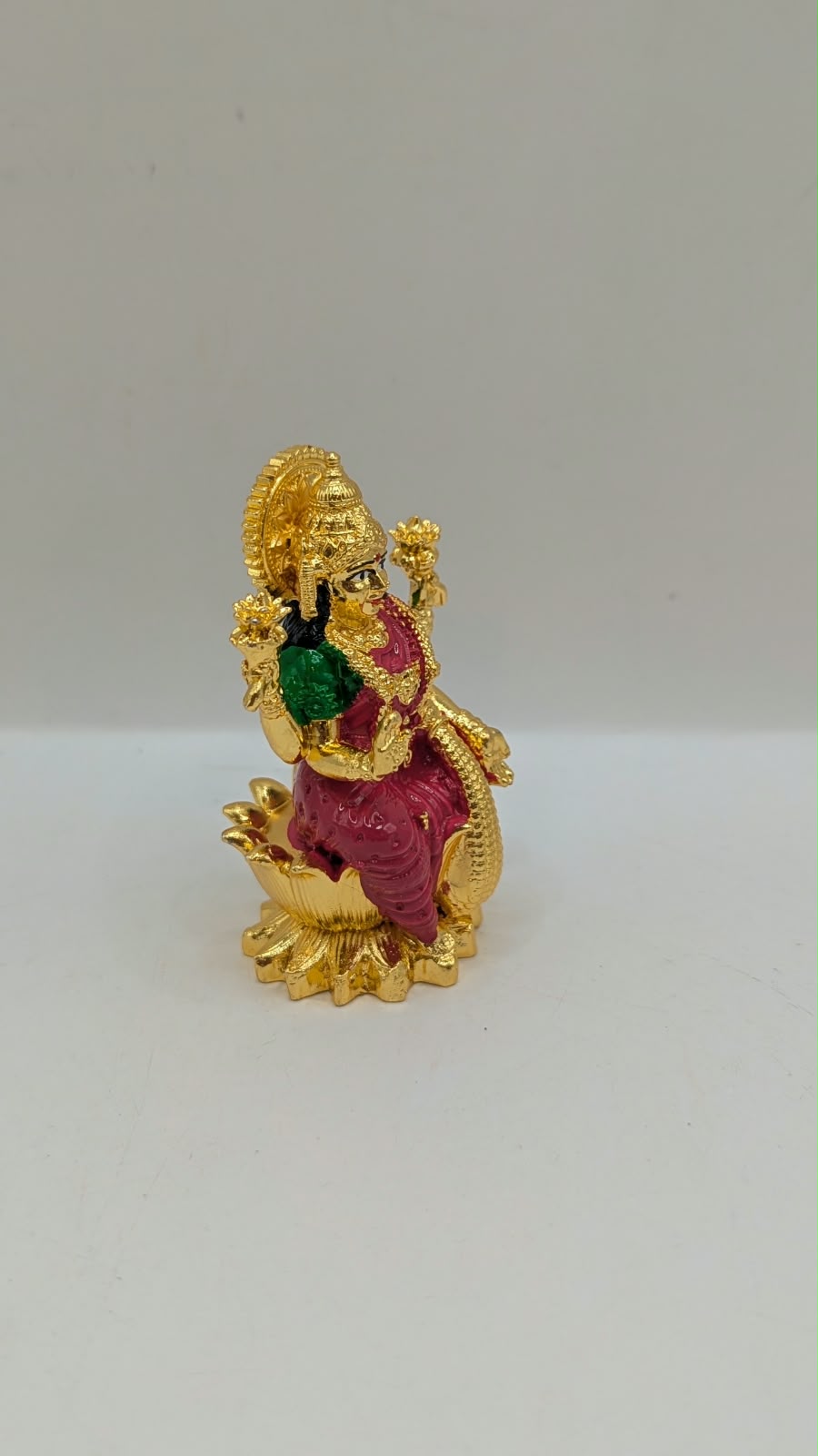 Gold Laxmi murti with pink saree, side view