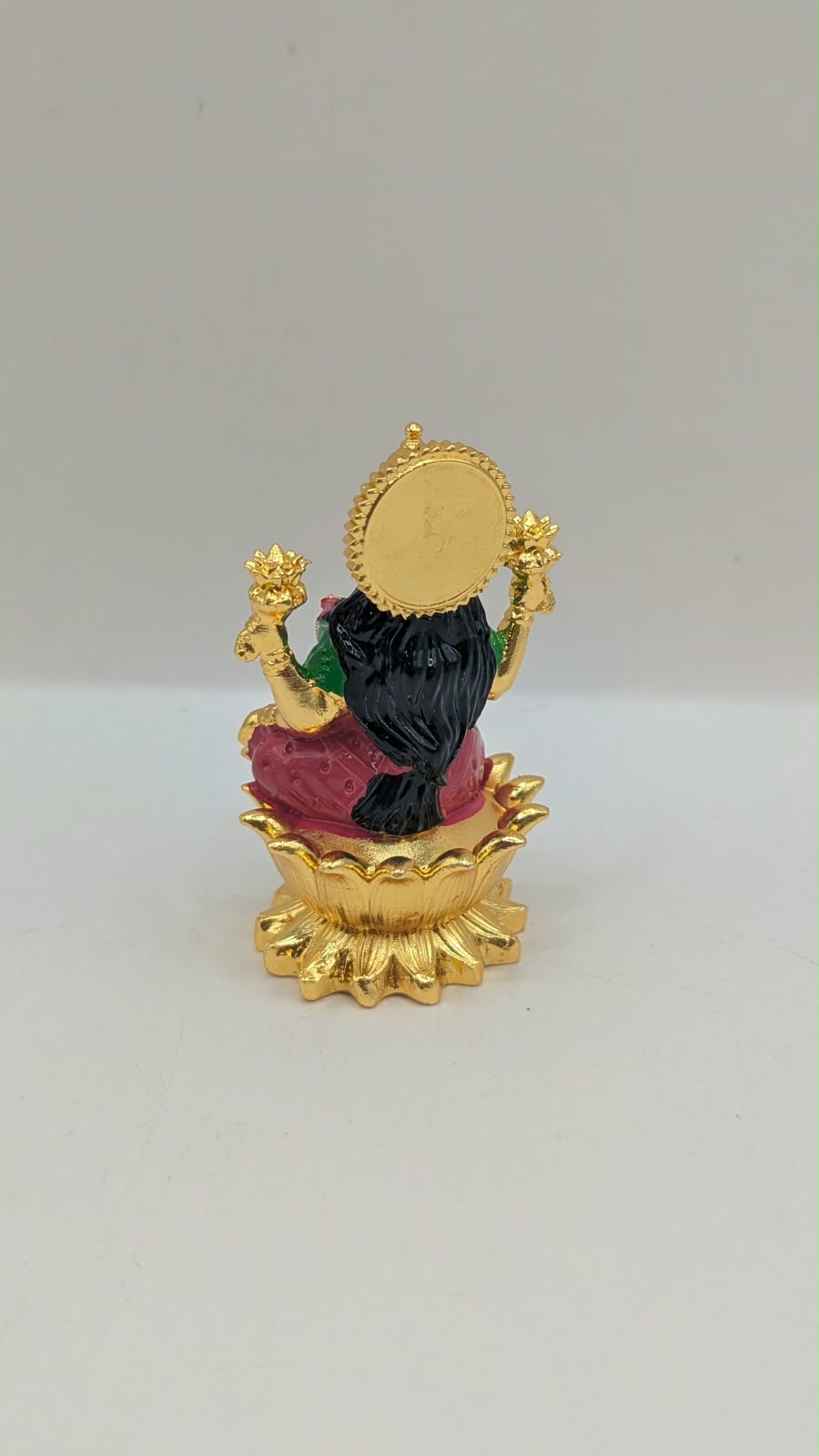 Gold Laxmi murti with pink saree, back view