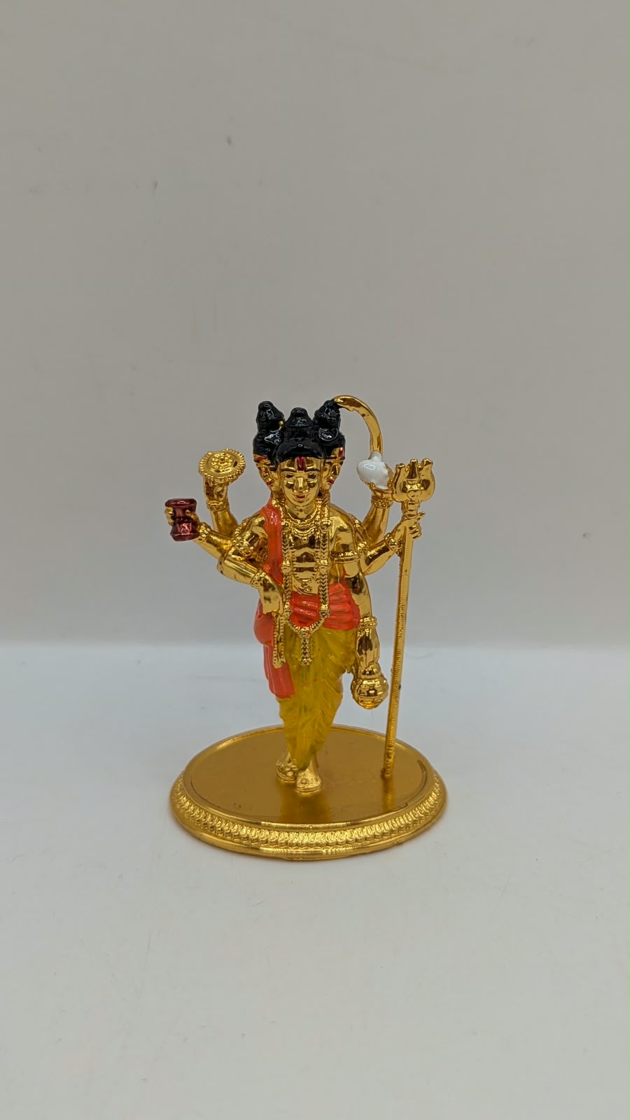 Gold Dattatreya murti, front view
