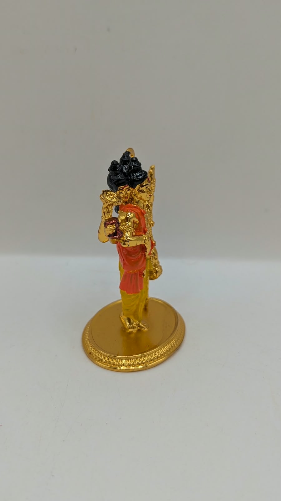 Gold Dattatreya murti, side view