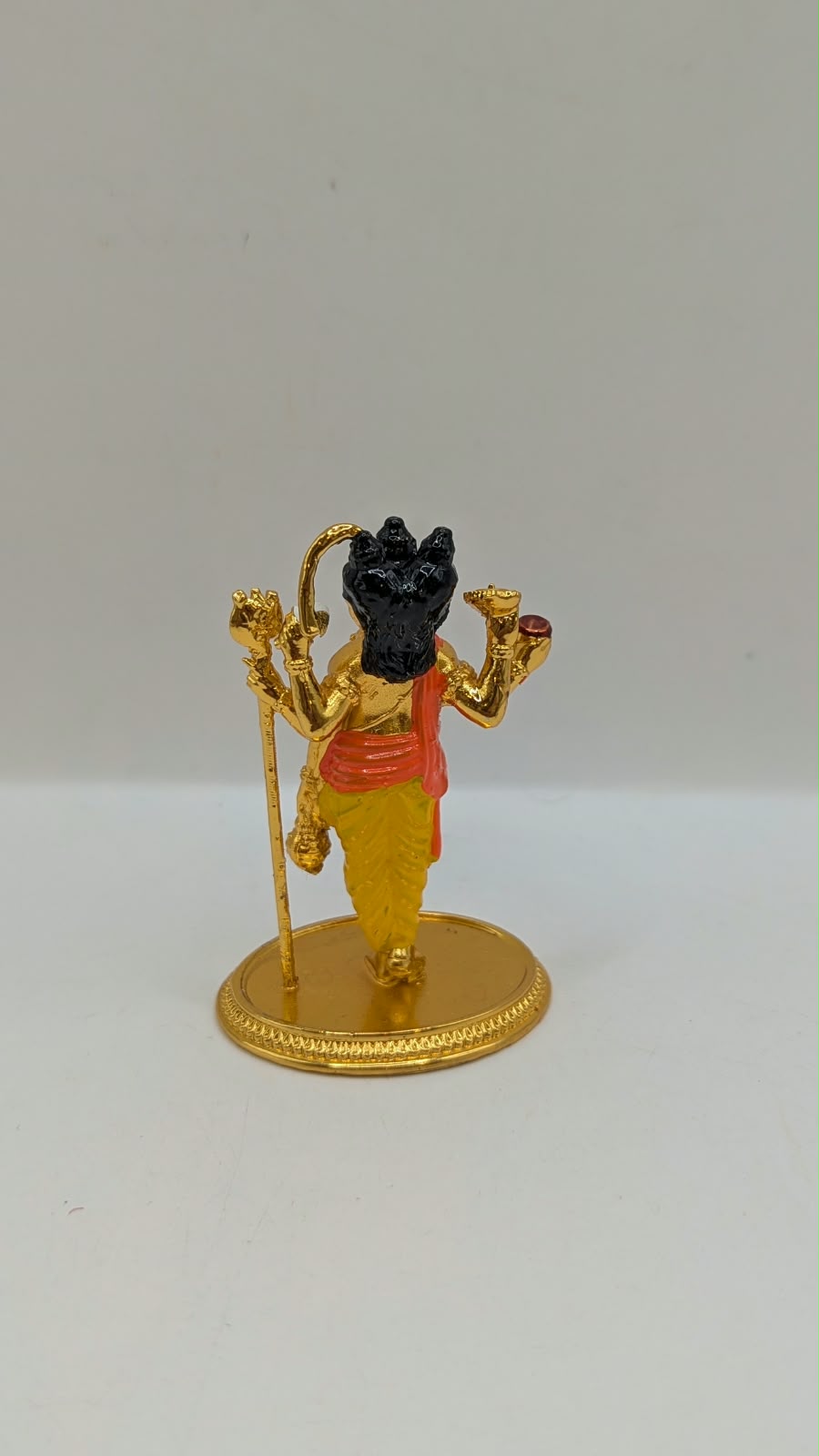 Gold Dattatreya murti, back view