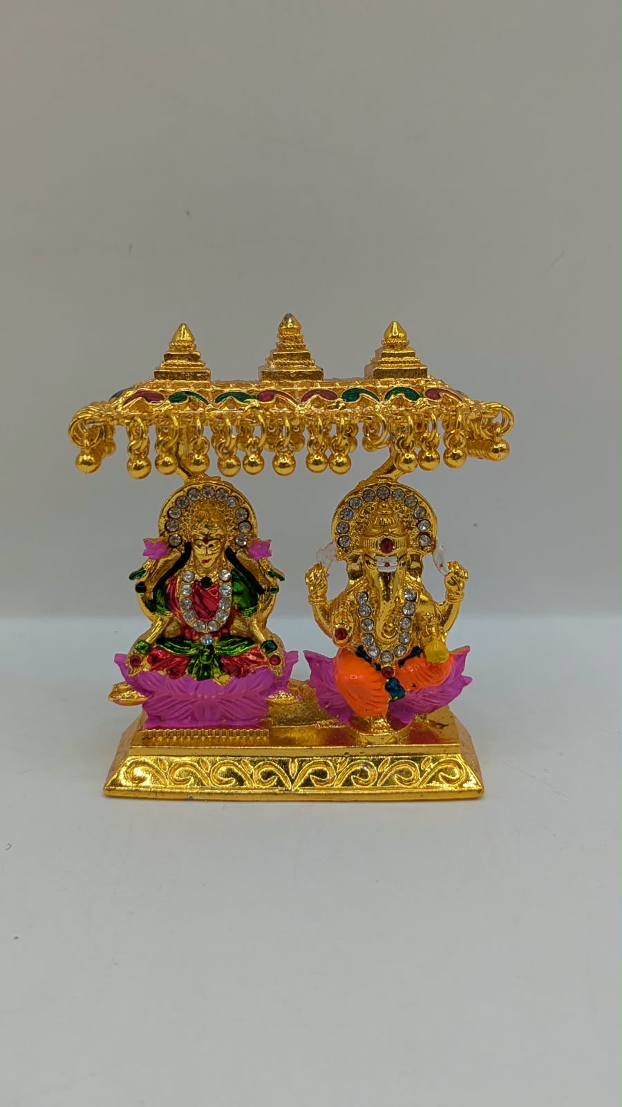 Gold Laxmi Ganesh murti with canopy, front view