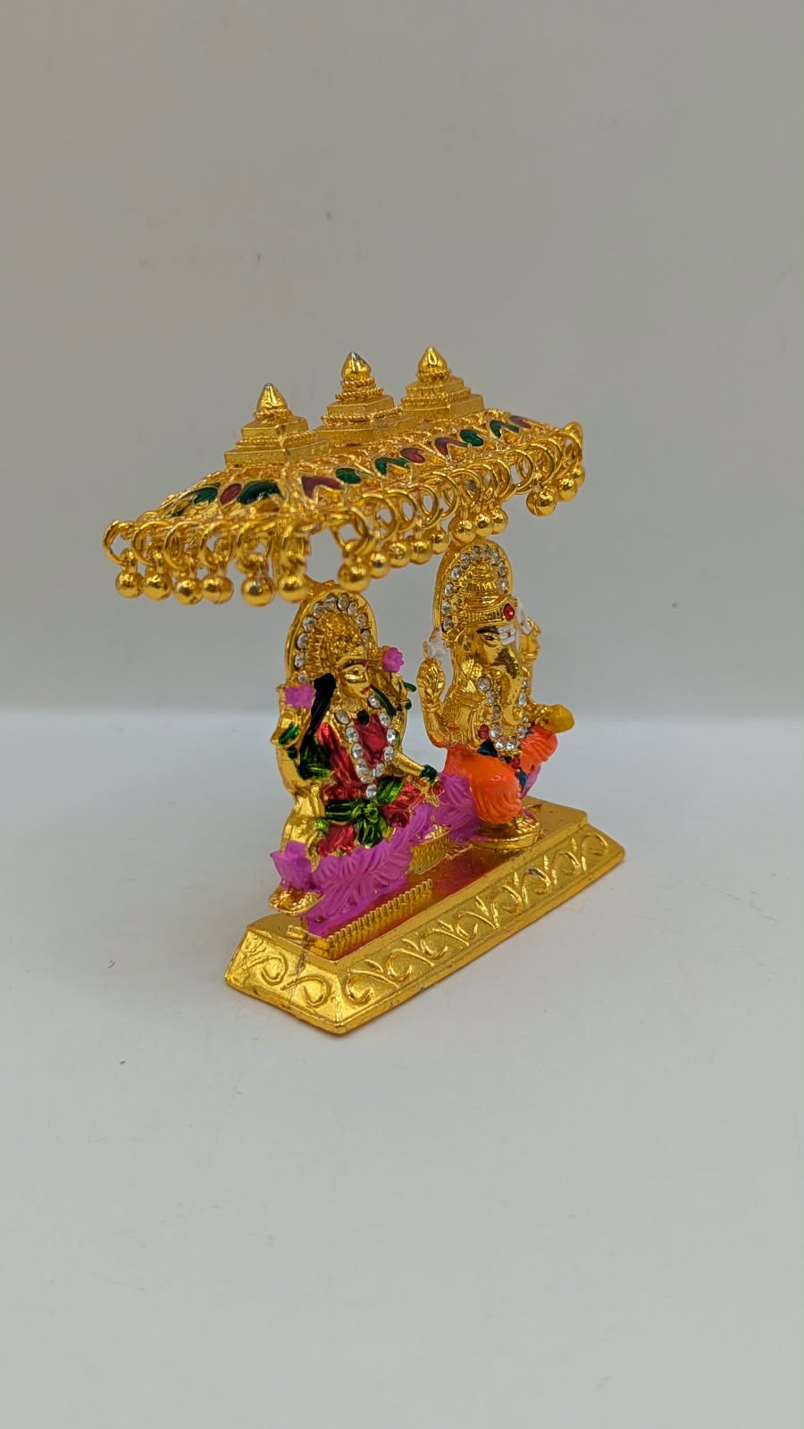 Gold Laxmi Ganesh murti with canopy, side view