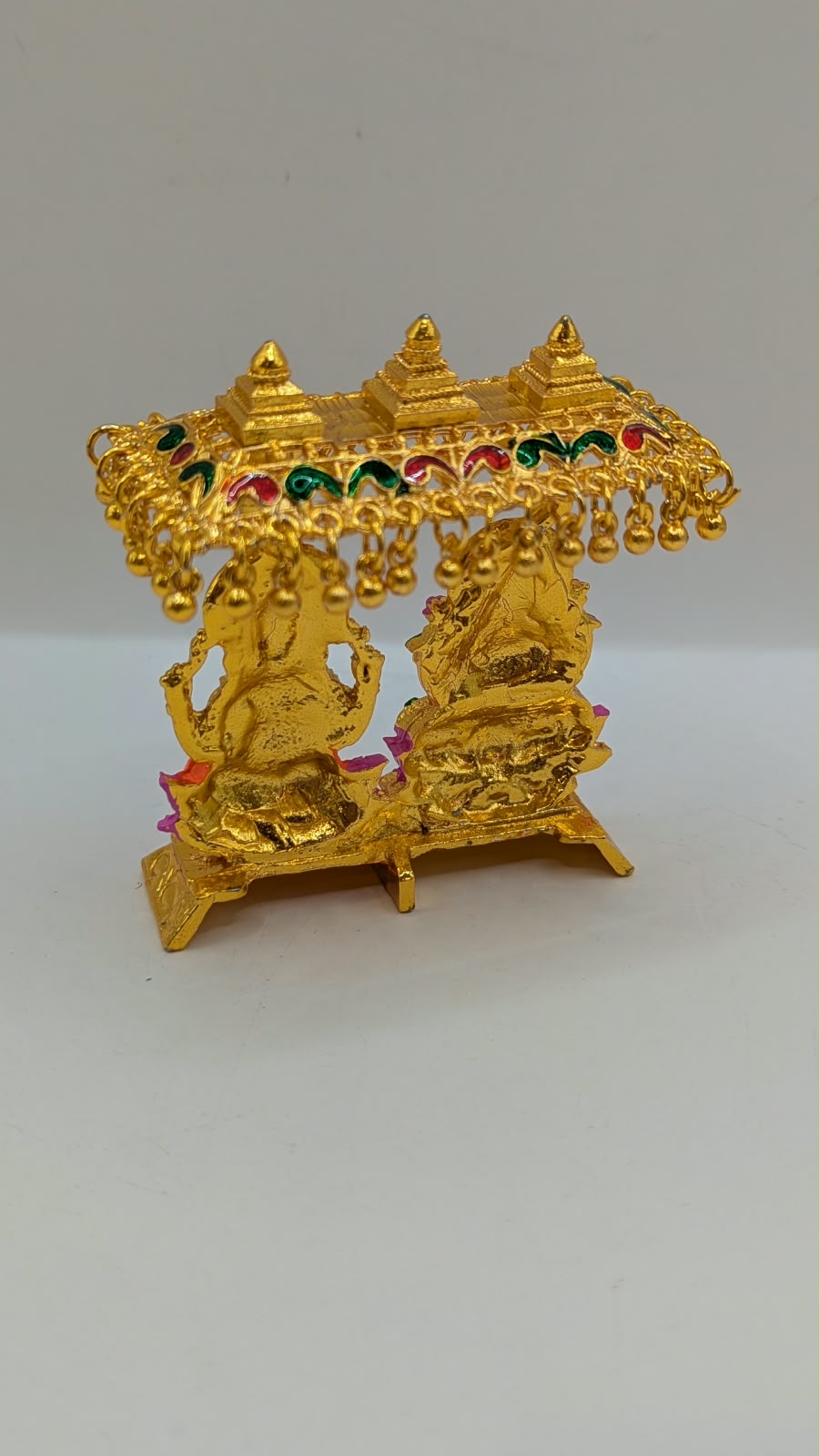 Gold Laxmi Ganesh murti with canopy, back view