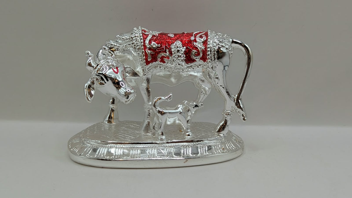 Silver Kamdhenu cow and calf statue, front view
