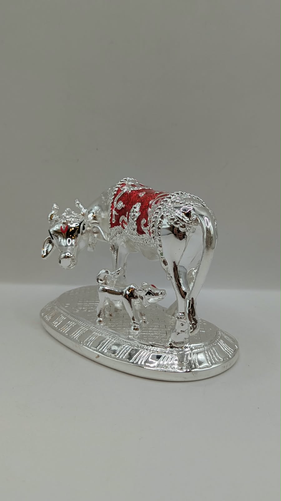 Silver Kamdhenu cow and calf statue, other side view