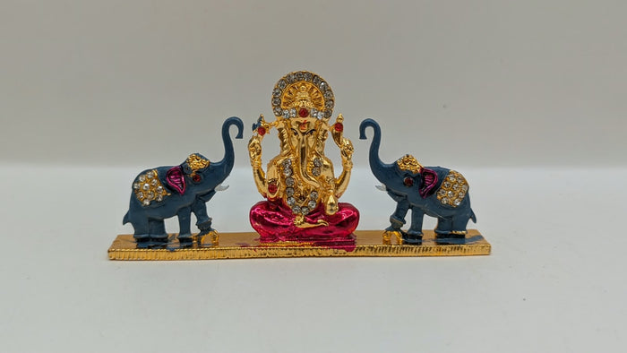 Gold Ganesh murti with two elephants, front view