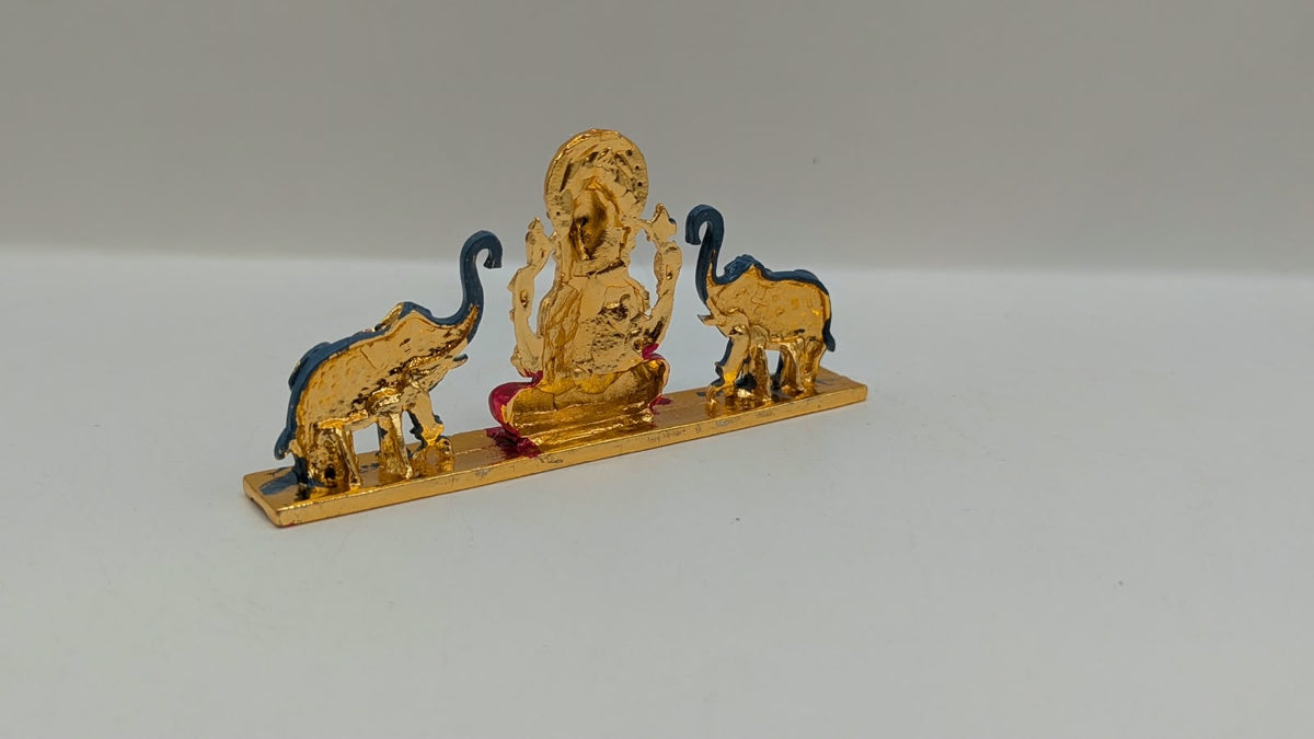 Gold Ganesh murti with two elephants, back view