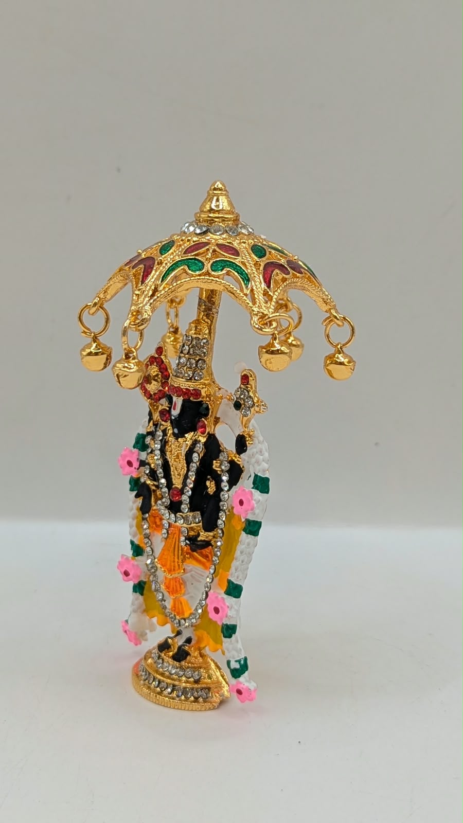 Gold Tirupati Balaji murti under umbrella, other side view