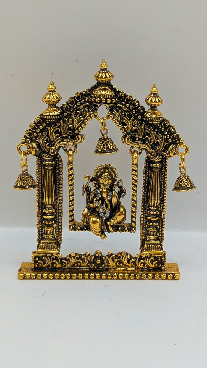Antique gold Ganesh jhula murti in temple arch, front view