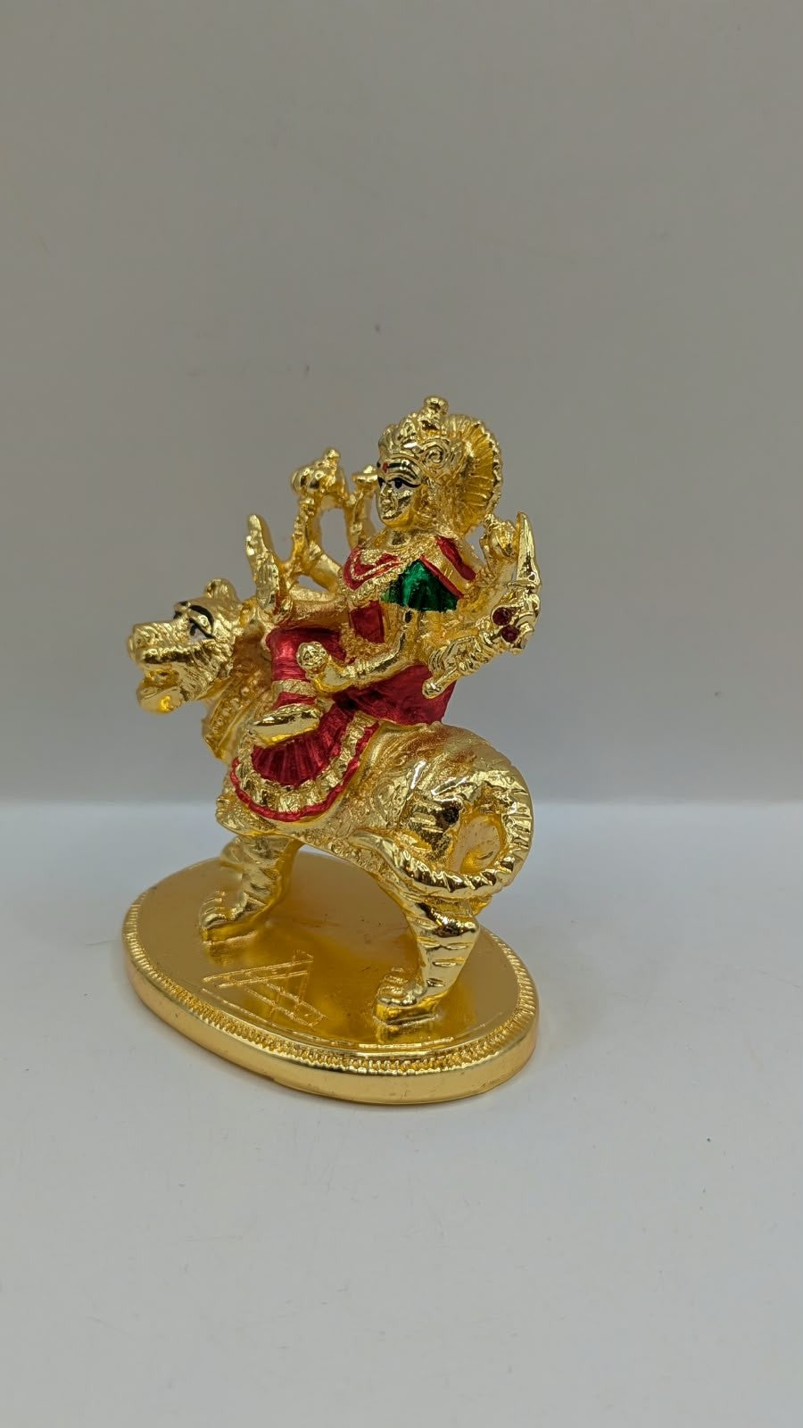 Gold Durga Mata murti with red saree on lion, other side view