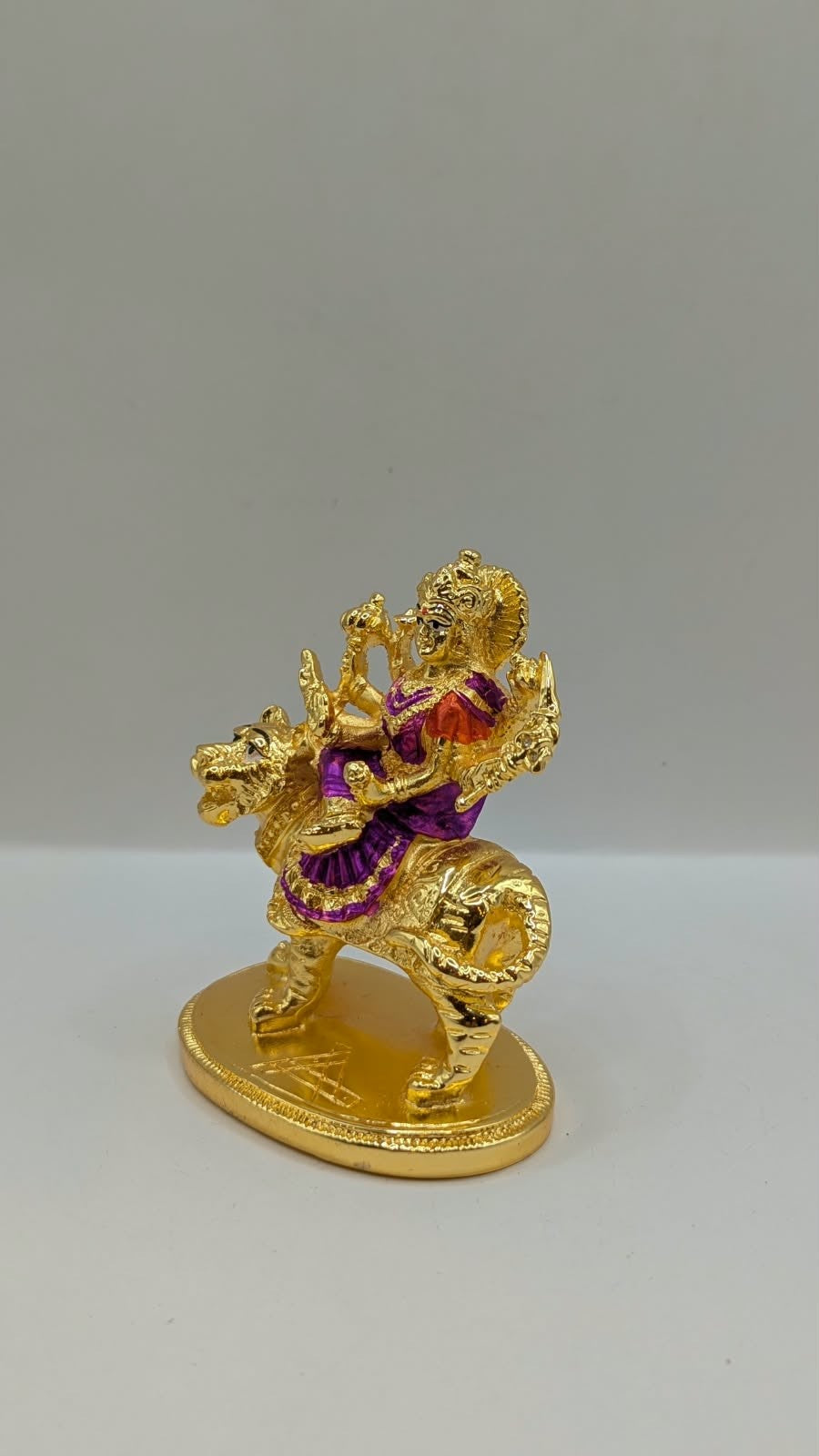 Gold Durga Mata murti with purple saree on lion, other side view
