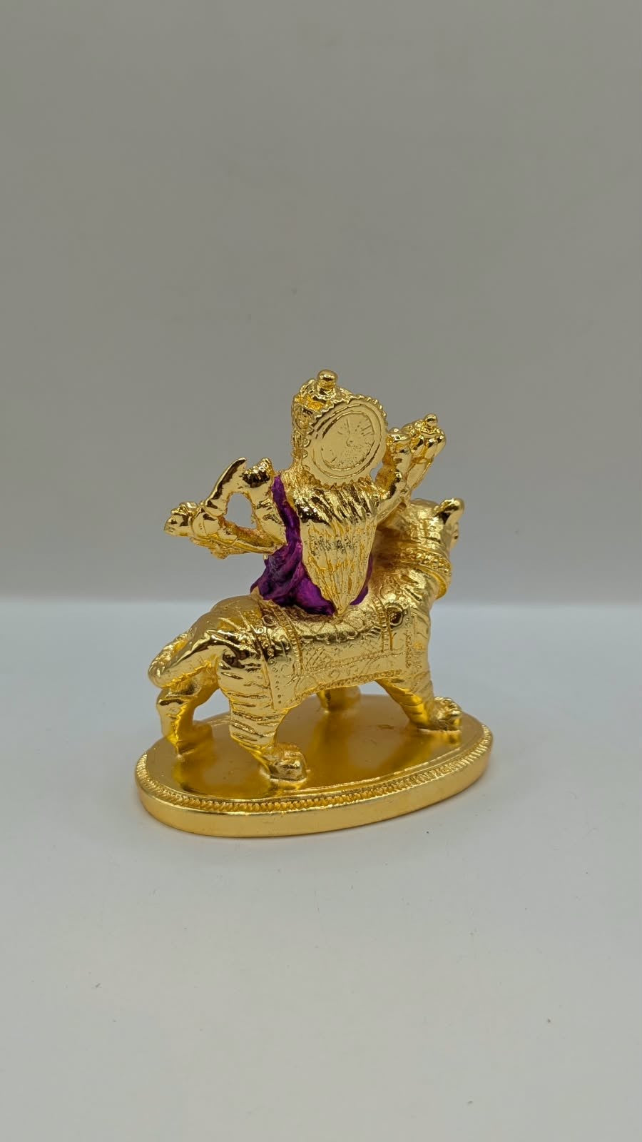 Gold Durga Mata murti with purple saree on lion, back view