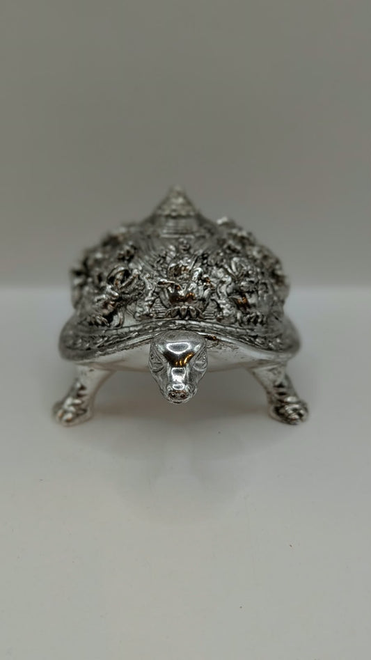 Silver finish metal tortoise with carved shell, front view