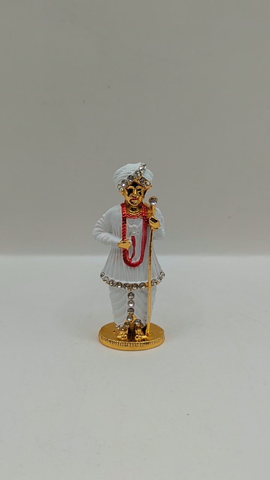 White and gold Jalaram Bapa murti, front view