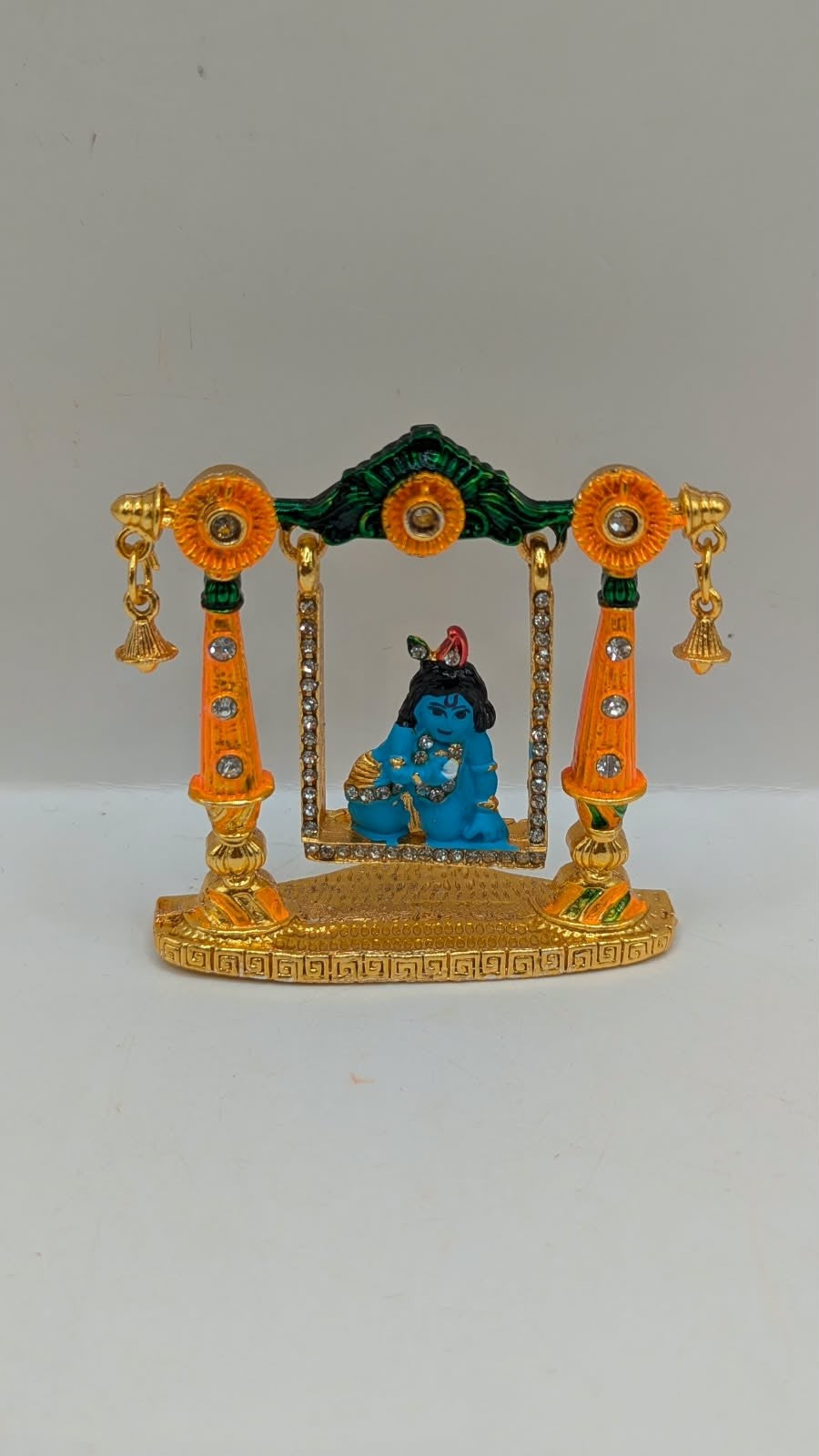 Bal Gopal on gold and orange jhula murti, front view