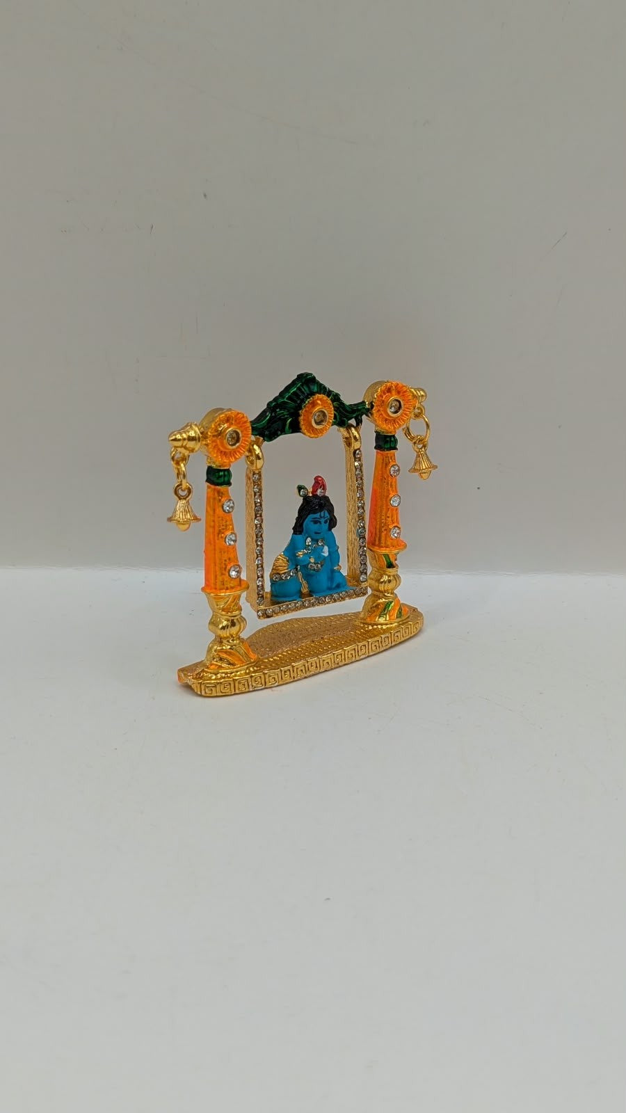 Bal Gopal on gold and orange jhula murti, side view