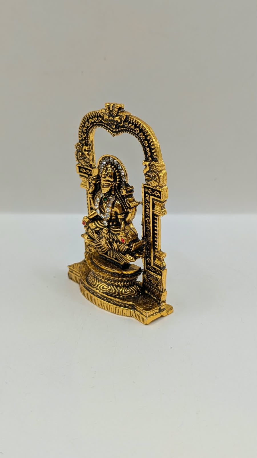 Antique gold Laxmi murti in temple arch, other side view