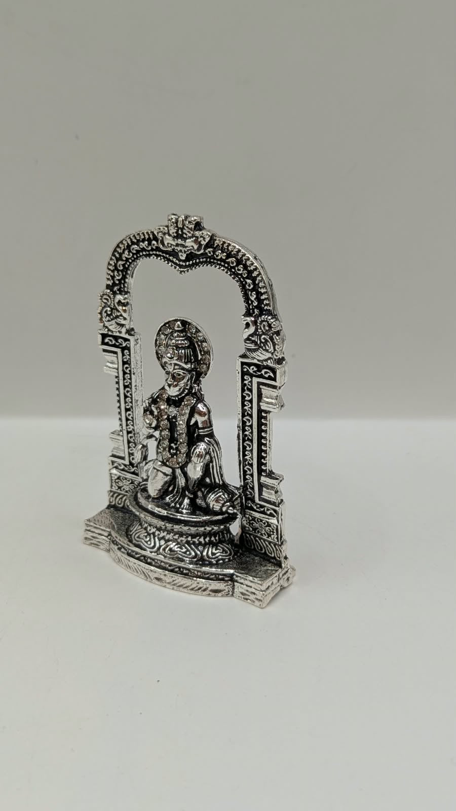 Silver Hanuman murti in temple arch, other side view