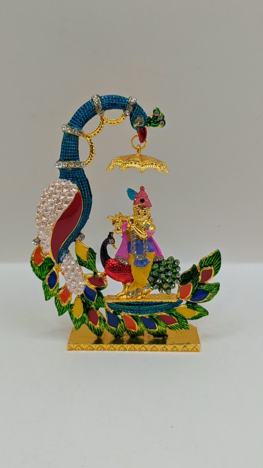 Colourful Krishna with peacock and umbrella murti, front view