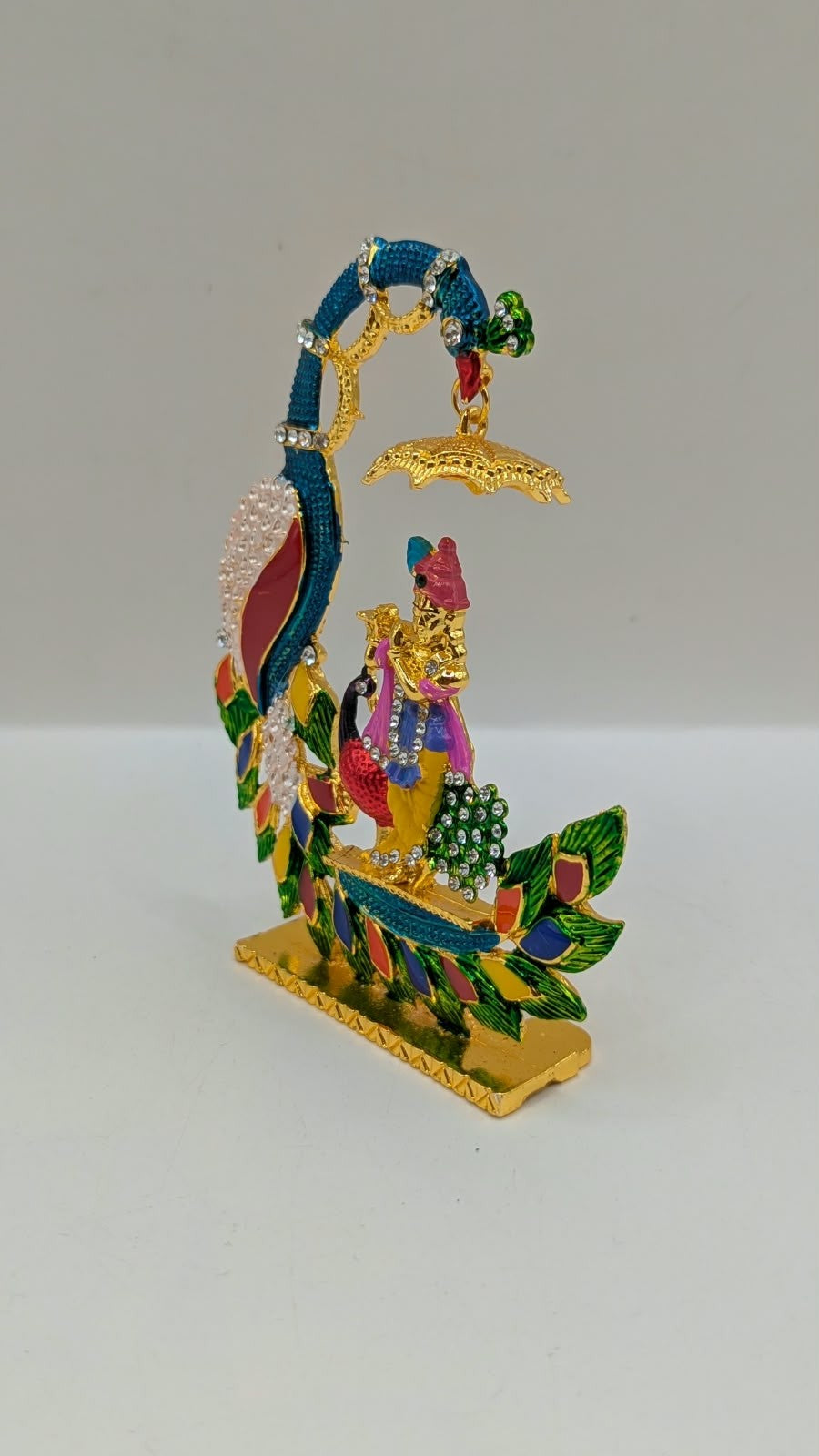 Colourful Krishna with peacock and umbrella murti, other side view