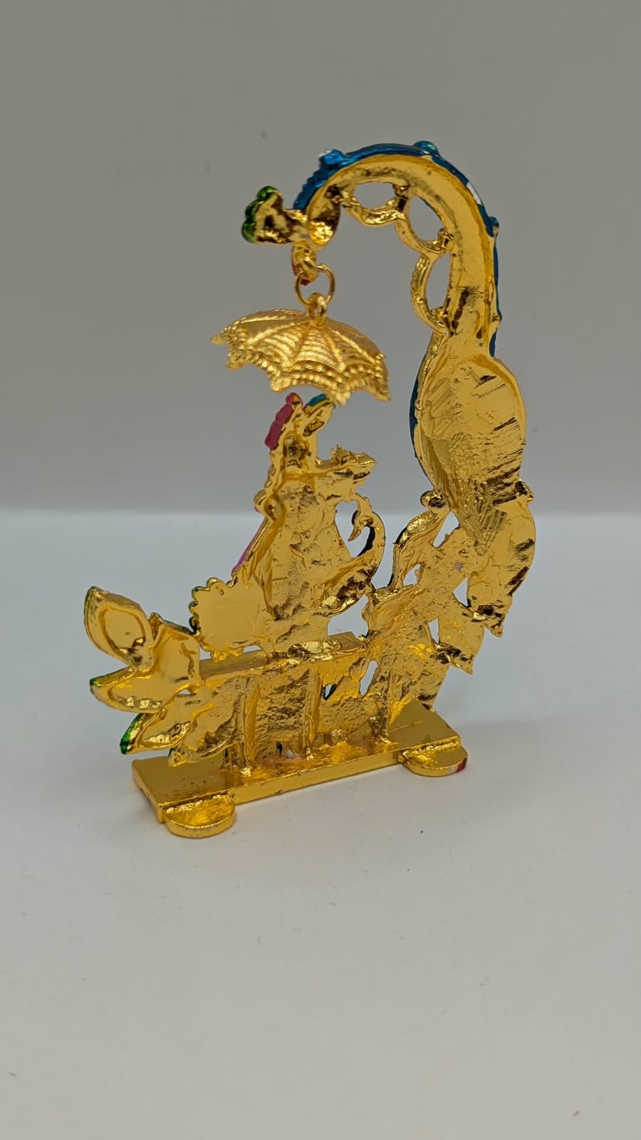 Colourful Krishna with peacock and umbrella murti, back view