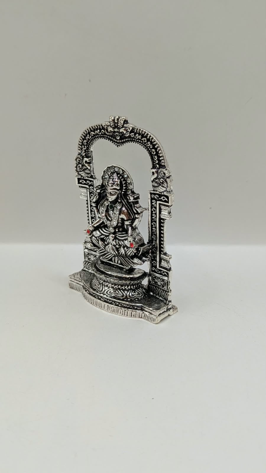 Silver Laxmi murti in temple arch, other side view