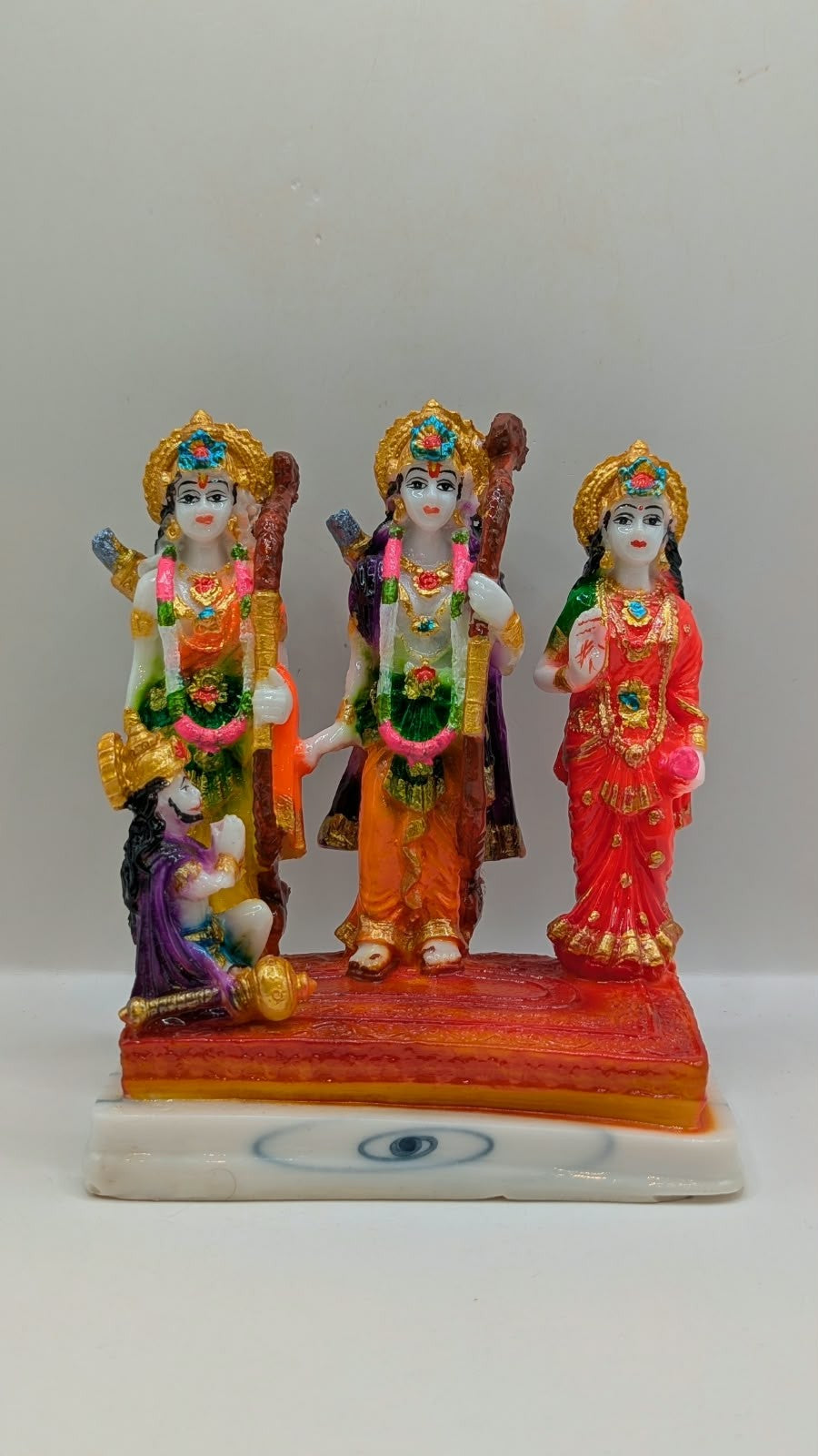 Colourful Ram Darbar resin statue on orange base, front view