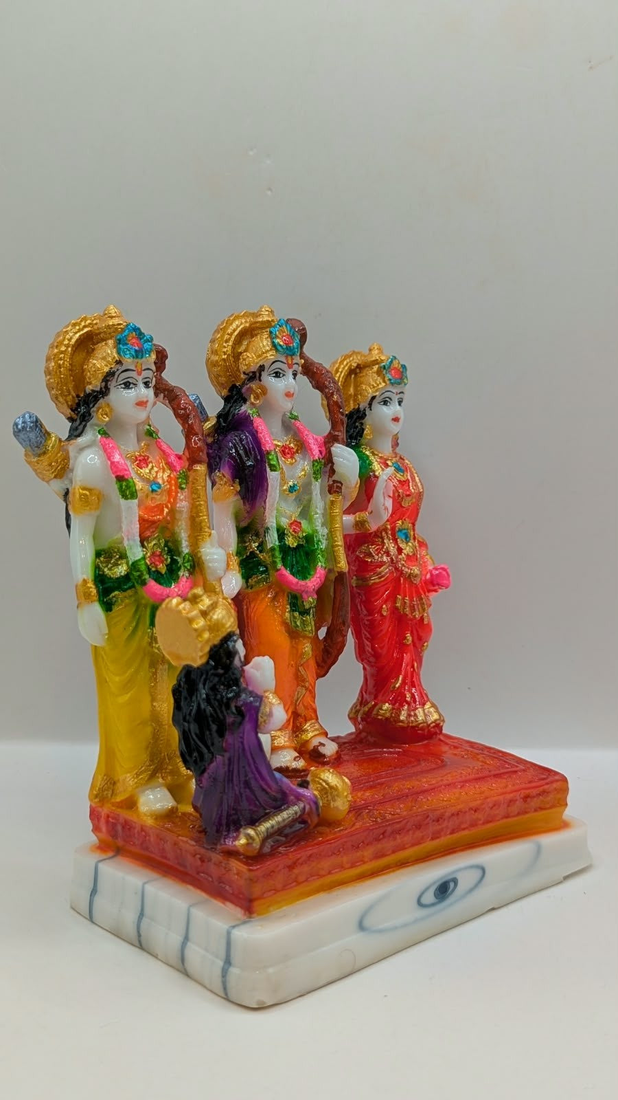 Colourful Ram Darbar resin statue on orange base, side view