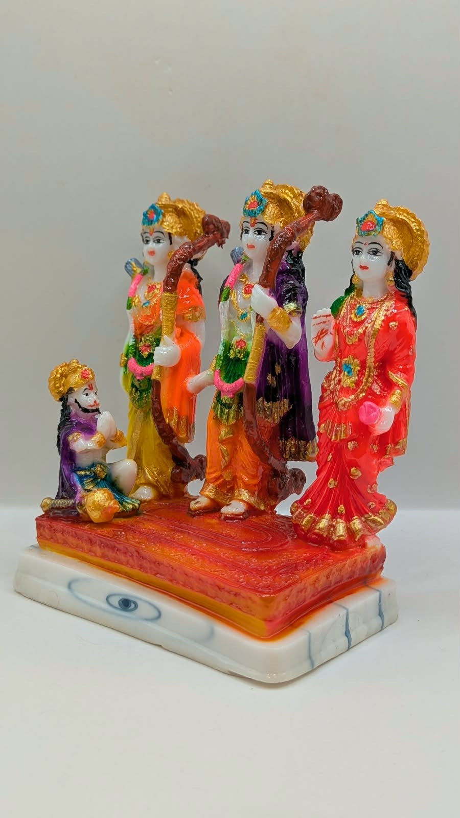 Colourful Ram Darbar resin statue on orange base, other side view