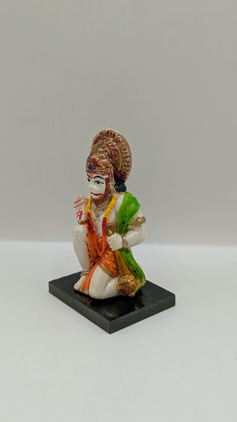 Green and orange kneeling Hanuman resin statue, other side view