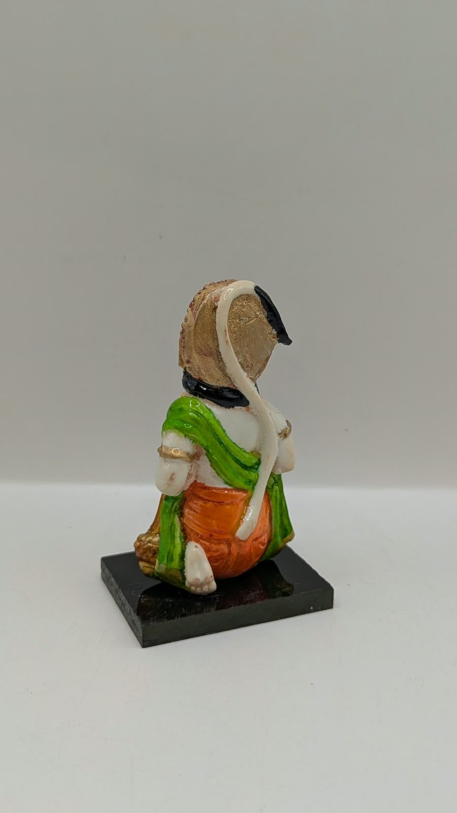 Green and orange kneeling Hanuman resin statue, back view