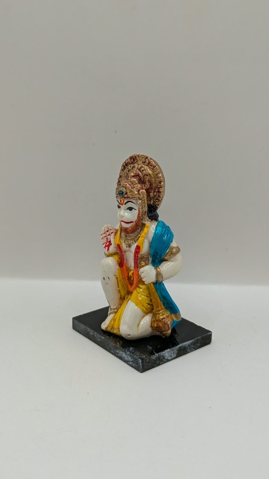 Blue and yellow kneeling Hanuman resin statue, other side view
