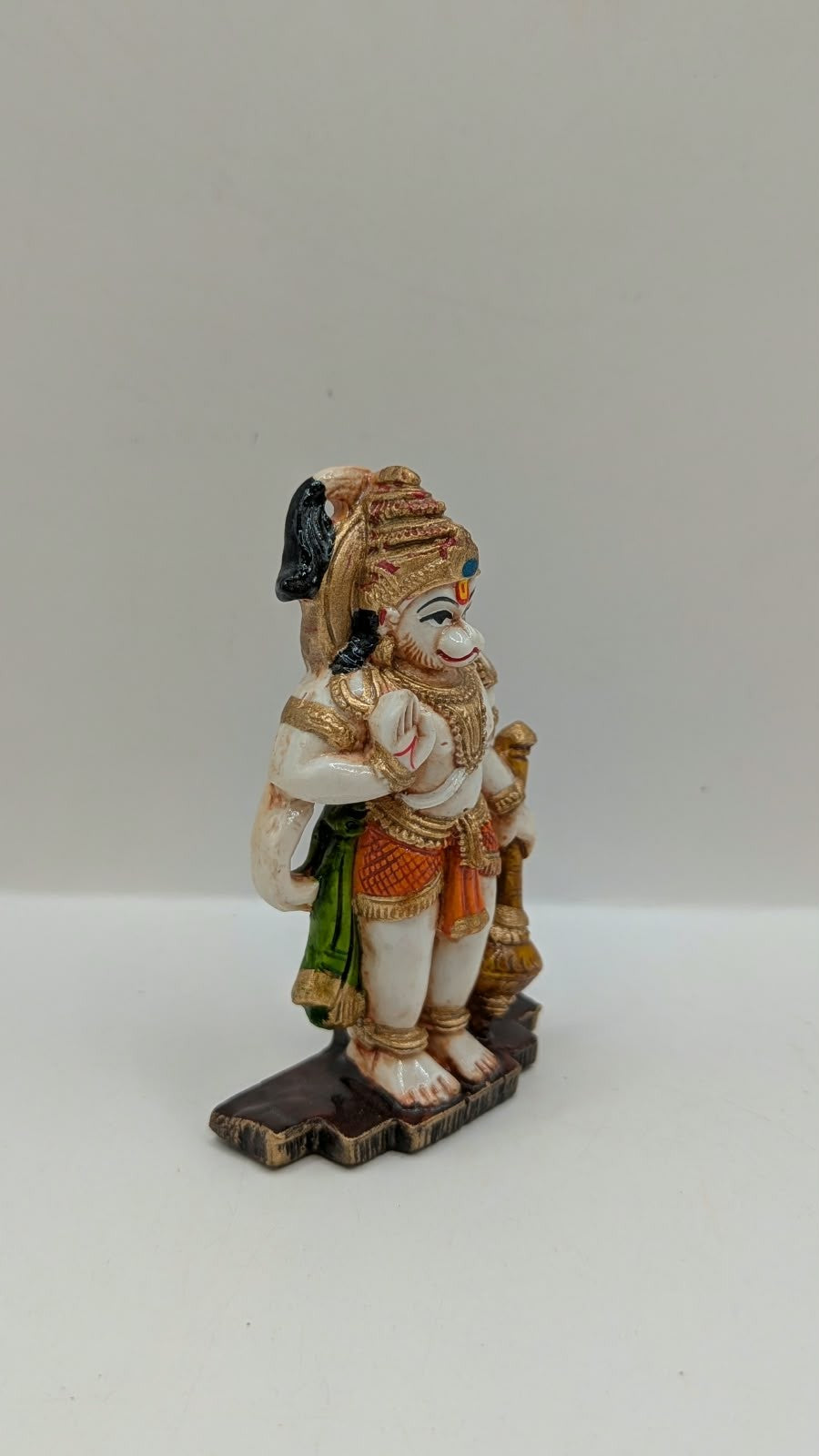 Green and orange standing Hanuman resin statue, side view