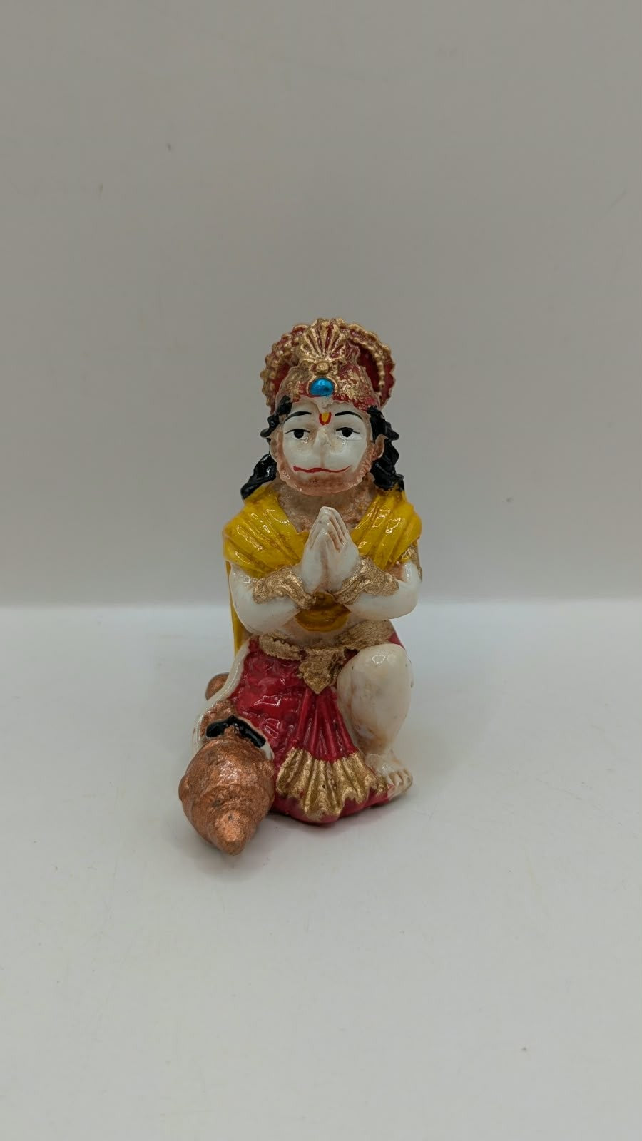 Yellow and red praying Hanuman resin statue, front view