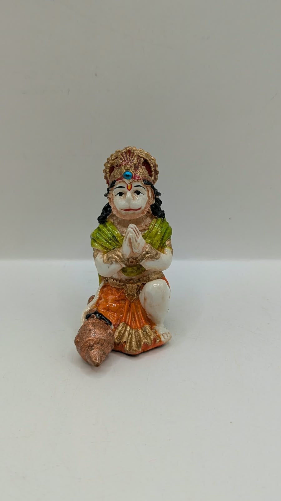 Green and orange praying Hanuman resin statue, front view