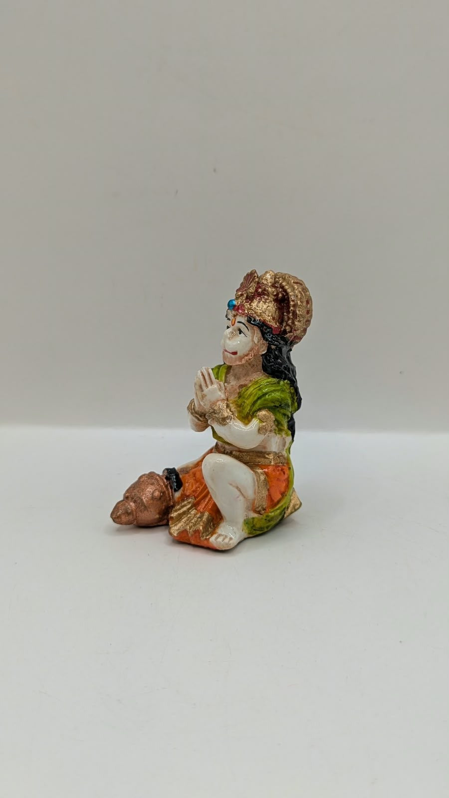 Green and orange praying Hanuman resin statue, other side view