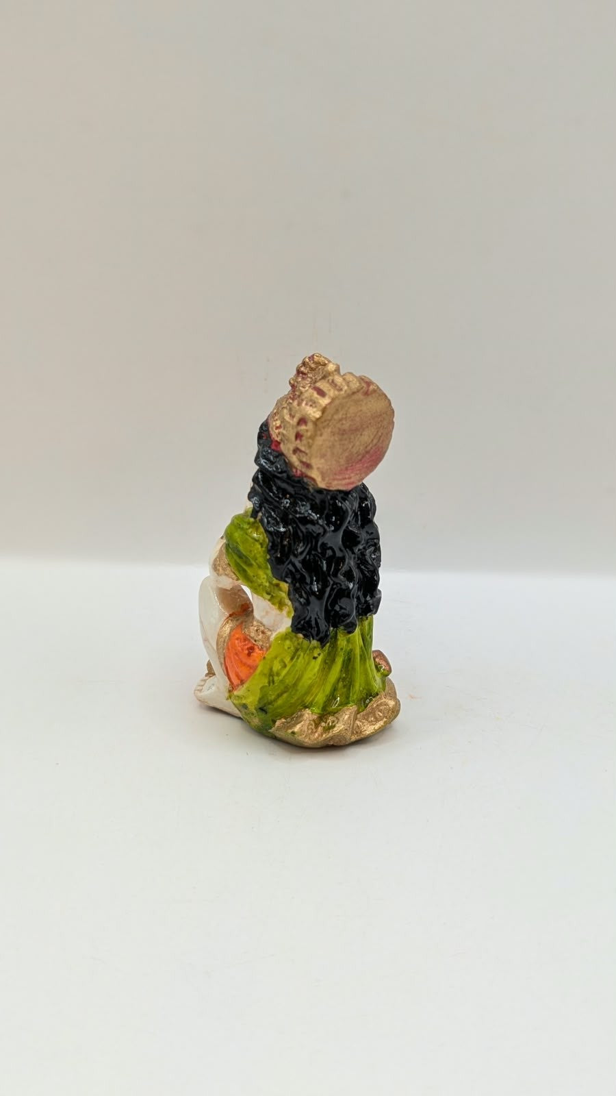Green and orange praying Hanuman resin statue, back view