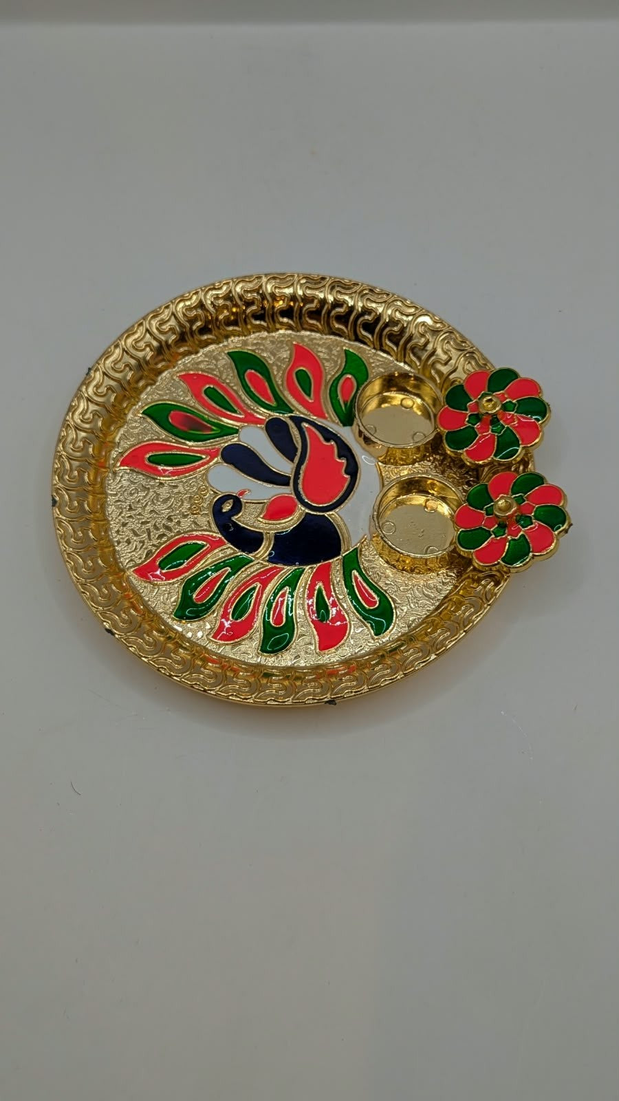 Gold peacock design puja thali with kumkum boxes open