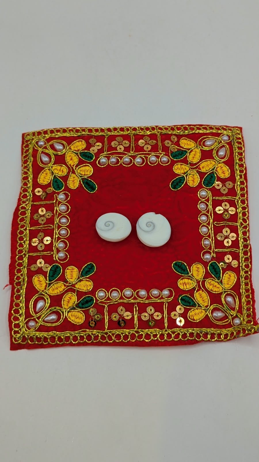 Two Gomti Chakra shells, spiral side