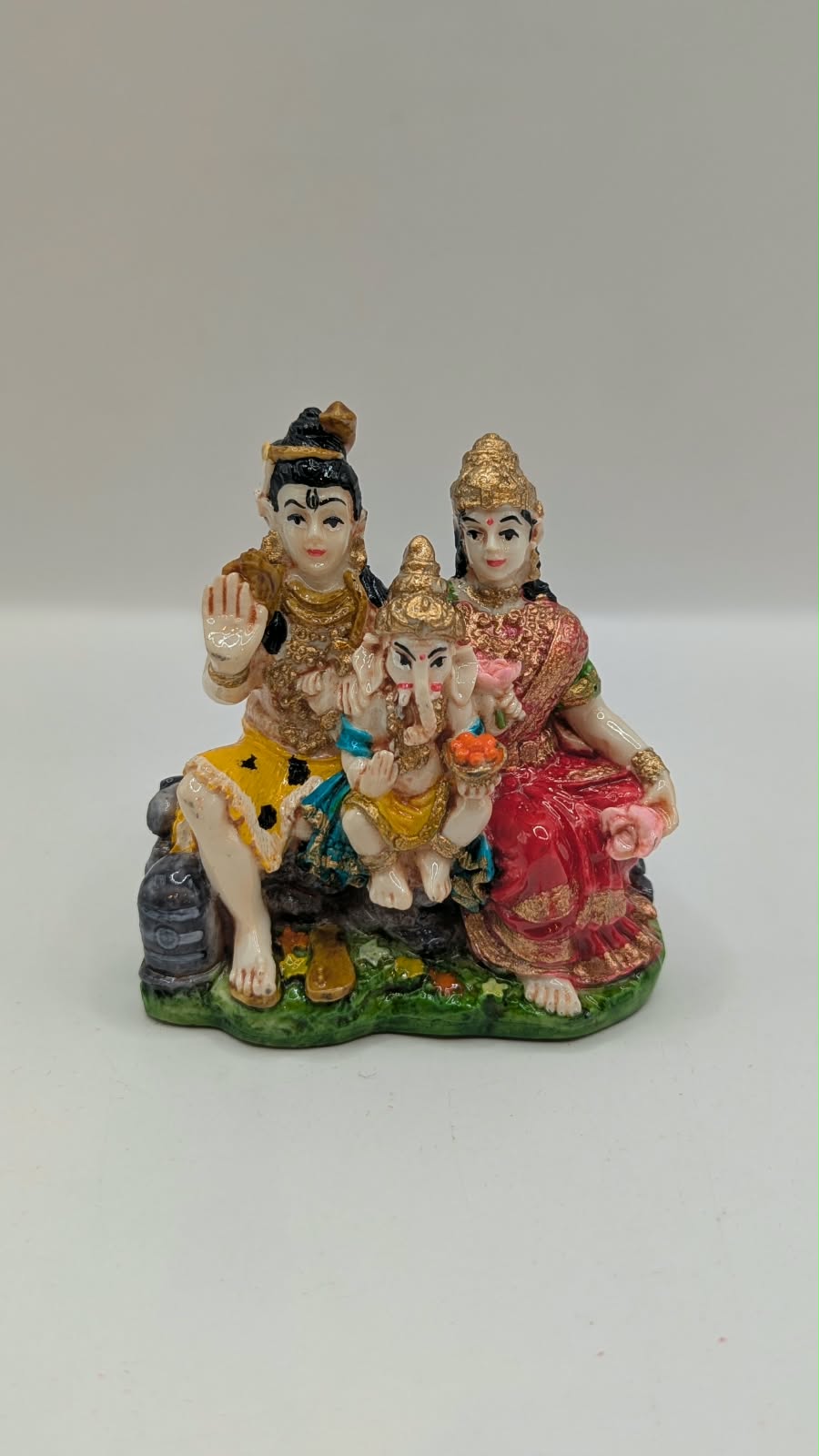 Colourful Shiv Parivar resin statue on green base, front view