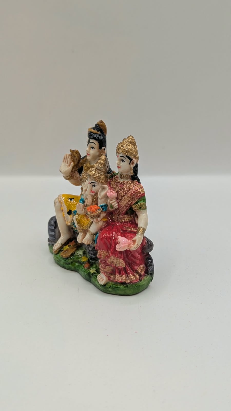 Colourful Shiv Parivar resin statue on green base, other side view